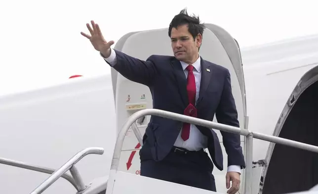 U.S. Secretary of State Marco Rubio waves goodbye as he boards a plane at Juan Santamaria International Airport near San Jose, Costa Rica, Tuesday, Feb. 4, 2025, en route to Guatemala. (AP Photo/Mark Schiefelbein, Pool)
