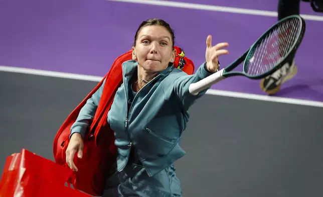 Romania's Simona Halep throws her racket into the tribune after announcing her retirement from professional tennis following a defeat at the Transylvania Open women's tennis tournament, Tuesday, Feb. 4, 2025, in Cluj, Romania. (Mihaela-Ionela Bobar/Action Foto Romania via AP)
