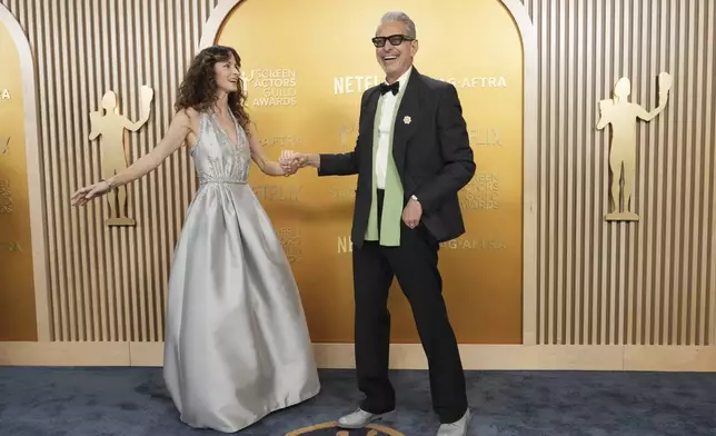 Emilie Livingston, left, and Jeff Goldblum arrive at the 31st annual Screen Actors Guild Awards on Sunday, Feb. 23, 2025, at the Shrine Auditorium in Los Angeles. (Photo by Jordan Strauss/Invision/AP)