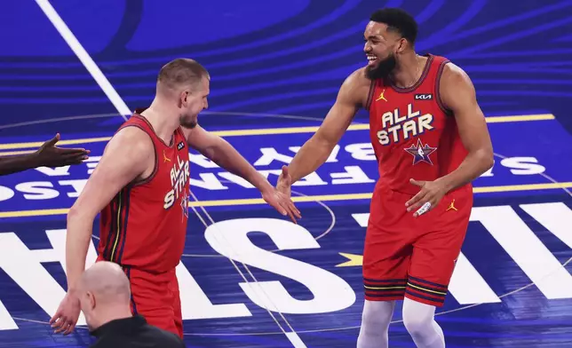 Denver Nuggets center Nikola Jokic, left, shakes hands with New York Knicks center Karl-Anthony Towns during the NBA All-Star basketball game Sunday, Feb. 16, 2025, in San Francisco. (AP Photo/Jed Jacobsohn)