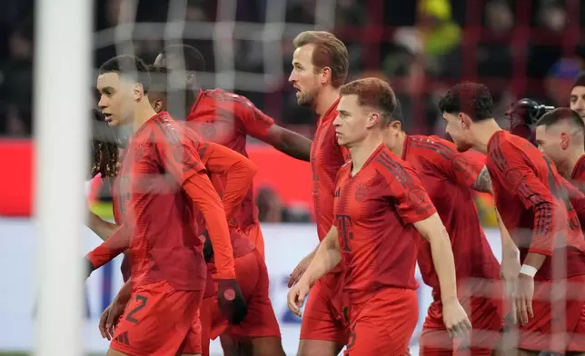 Players celebrate after Bayern's Harry Kane, center, scored the first goal of the match on a penalty shot during the German Bundesliga soccer match between Bayern Munich and Werder Bremen at the Allianz Arena in Munich, Germany, Friday, Feb. 7, 2025. (AP Photo/Matthias Schrader)