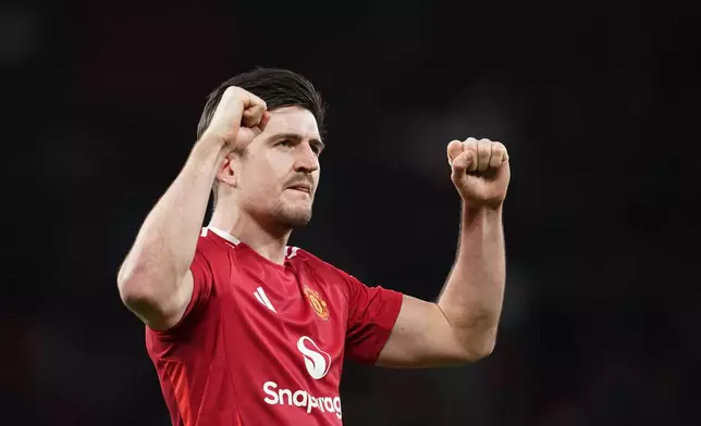 Manchester United's Harry Maguire celebrates after the English FA Cup fourth round soccer match between Manchester United and Leicester City at the Old Trafford stadium in Manchester, England, Friday, Feb. 7, 2025. (AP Photo/Dave Thompson)