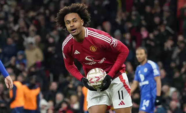 Manchester United's Joshua Zirkzee celebrates after scoring his side's first goal during the English FA Cup fourth round soccer match between Manchester United and Leicester City at the Old Trafford stadium in Manchester, England, Friday, Feb. 7, 2025. (AP Photo/Dave Thompson)