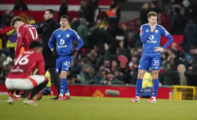 From right: Leicester's Kasey McAtee, Facundo Buonanotte and head coach Ruud van Nistelrooy react after the English FA Cup fourth round soccer match between Manchester United and Leicester City at the Old Trafford stadium in Manchester, England, Friday, Feb. 7, 2025. (AP Photo/Dave Thompson)