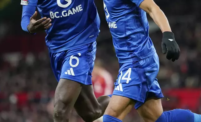 Leicester's Bobby Decordova-Reid, right, celebrates with Leicester's Wilfred Ndidi after scoring the opening goal during the English FA Cup fourth round soccer match between Manchester United and Leicester City at the Old Trafford stadium in Manchester, England, Friday, Feb. 7, 2025. (AP Photo/Dave Thompson)