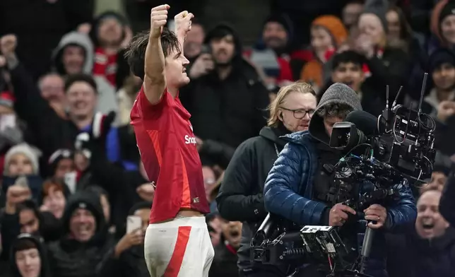 Manchester United's Harry Maguire celebrates after scoring his side's second goal during the English FA Cup fourth round soccer match between Manchester United and Leicester City at the Old Trafford stadium in Manchester, England, Friday, Feb. 7, 2025. (AP Photo/Dave Thompson)