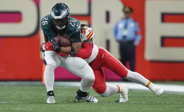 Philadelphia Eagles running back Saquon Barkley (26) catches a pass as Kansas City Chiefs linebacker Nick Bolton (32) defends during the first half of the NFL Super Bowl 59 football game, Sunday, Feb. 9, 2025, in New Orleans. (AP Photo/Doug Benc)