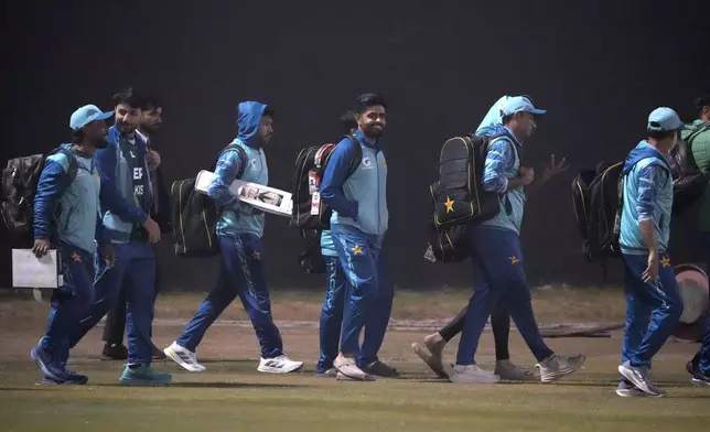 Pakistan's Babar Azam, center, with teammates arrive for a training session, in Lahore, Pakistan, Thursday, Feb. 6, 2025. (AP Photo/K.M Chaudary)