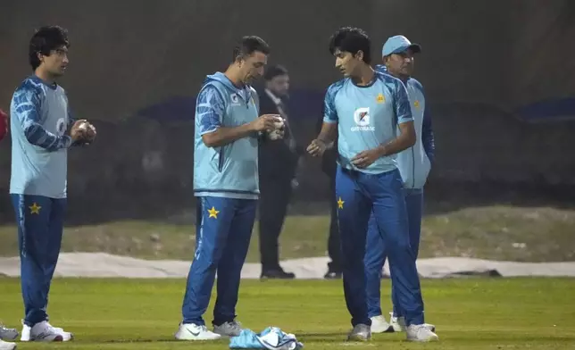 Pakistan's Naseem Shah, left, and Muhammad Hasnain, right, attend a training session, in Lahore, Pakistan, Thursday, Feb. 6, 2025. (AP Photo/K.M Chaudary)