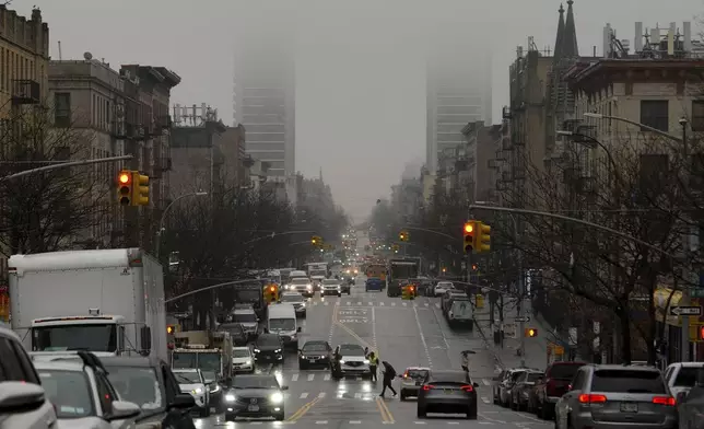 Cars drive through rain, Thursday, Feb. 6, 2025, in New York. (AP Photo/Julia Demaree Nikhinson)