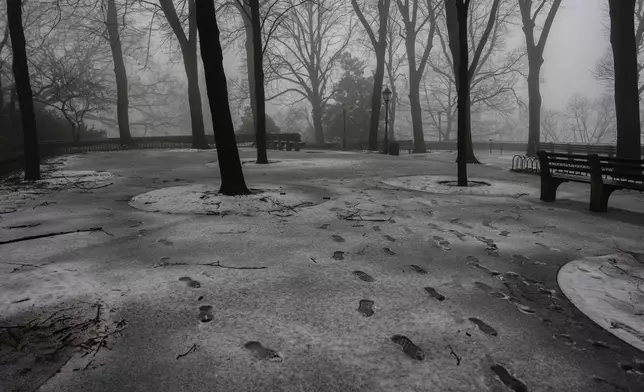Footprints are seen in snow in Fort Tryon Park, Thursday, Feb. 6, 2025, in New York. (AP Photo/Julia Demaree Nikhinson)