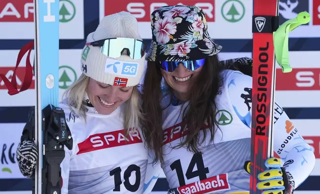 Norway's Kajsa Vickhoff Lie celebrates on the podium after taking joint third place with United States' Lauren Macuga, right, in a women's Super-G, at the Alpine Ski World Championships, in Saalbach-Hinterglemm, Austria, Thursday, Feb. 6, 2025. (AP Photo/Giovanni Auletta)