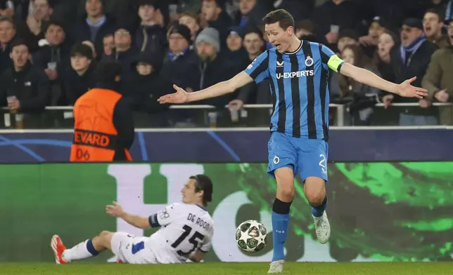 Brugge's Hans Vanaken, right, reacts as the Atalanta's Marten de Roon is seen on the ground during the Champions League playoff first leg soccer match between Club Brugge and Atalanta at the Jan Breydel Stadium in Bruges, Belgium, Wednesday, Feb. 12, 2025. (AP Photo/Geert Vanden Wijngaert)