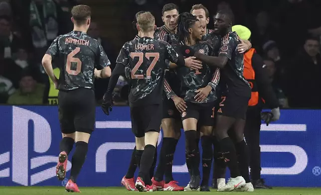 Bayern's Michael Olise, center, celebrates with team mates after scoring his side's opening goal during the Champions League play off first leg soccer match between Celtic Glasgow and Bayern Munich at the Celtic Park Stadium in Glasgow, Scotland, Wednesday, Feb. 12, 2025. (AP Photo/Scott Heppell)