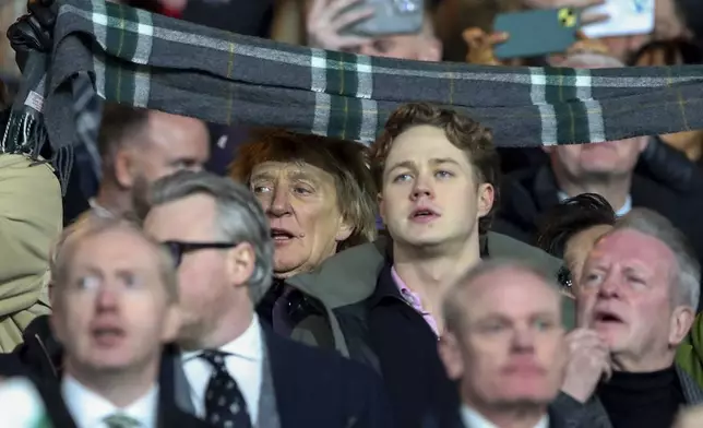 British pop icon Rod Stewart cheers the teams prior to the Champions League play off first leg soccer match between Celtic Glasgow and Bayern Munich at the Celtic Park Stadium in Glasgow, Scotland, Wednesday, Feb. 12, 2025. (AP Photo/Scott Heppell)
