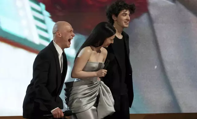 Yura Borisov, from left, Mikey Madison, and Mark Eydelshteyn speak about "Anora" during the 31st annual Screen Actors Guild Awards on Sunday, Feb. 23, 2025, at the Shrine Auditorium in Los Angeles. (AP Photo/Chris Pizzello)