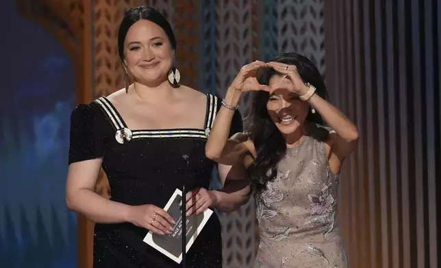 Lily Gladstone, left, and Michelle Yeoh present the award for outstanding performance by a male lead actor in a leading role during the 31st annual Screen Actors Guild Awards on Sunday, Feb. 23, 2025, at the Shrine Auditorium in Los Angeles. (AP Photo/Chris Pizzello)