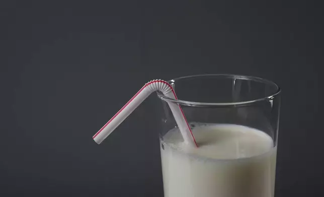 A plastic straw is displayed in a glass of milk, Tuesday, Feb. 11, 2025, in Cincinnati. (AP Photo/Joshua A. Bickel)