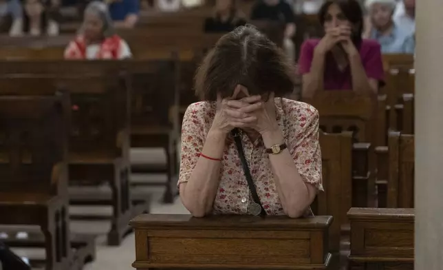 Faithful pray for Pope Francis' health during a Mass in Buenos Aires, Argentina, Wednesday, Feb. 19, 2025. (AP Photo/Rodrigo Abd)
