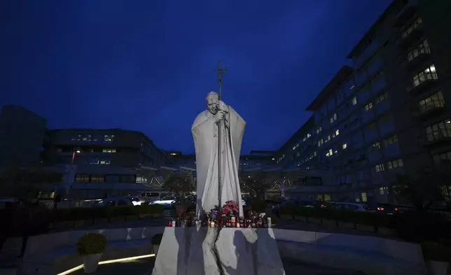 A statue of Pope John Paul II is seen in front of the Agostino Gemelli Polyclinic, Rome, Wednesday, Feb. 19, 2025, where the Pontiff is hospitalized since Friday, Feb. 14. (AP Photo/Andrew Medichini)