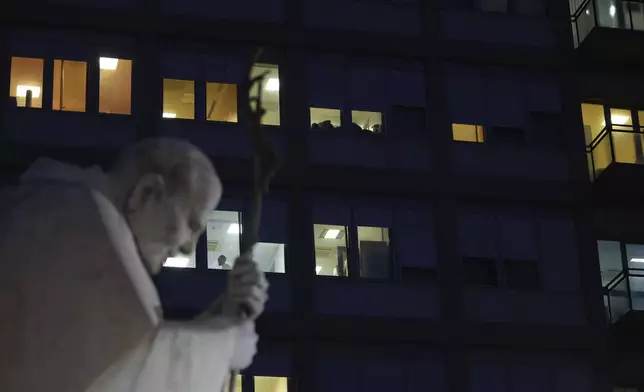 A statue of Pope John Paul II is seen in front of the Agostino Gemelli Polyclinic, Rome, Wednesday, Feb. 19, 2025, where the Pontiff is hospitalized since Friday, Feb. 14. (AP Photo/Andrew Medichini)