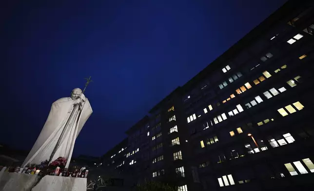 A statue of Pope John Paul II is seen in front of the Agostino Gemelli Polyclinic, Rome, Wednesday, Feb. 19, 2025, where the Pontiff is hospitalized since Friday, Feb. 14. (AP Photo/Andrew Medichini)