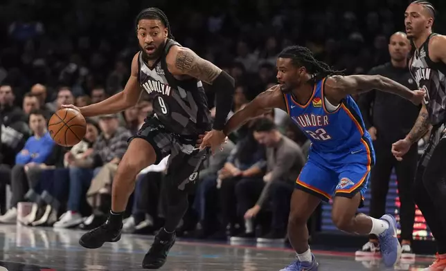 Brooklyn Nets' Trendon Watford (9) drives past Oklahoma City Thunder's Cason Wallace (22) during the first half of an NBA basketball game Wednesday, Feb. 26, 2025, in New York. (AP Photo/Frank Franklin II)