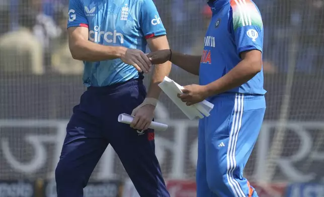 India's captain Rohit Sharma, right, shakes hand with his England counterpart Jos Buttler before the coin toss for the second one day international cricket match between India and England in Cuttack, India, Sunday, Feb. 9, 2025. (AP Photo/Rafiq Maqbool)