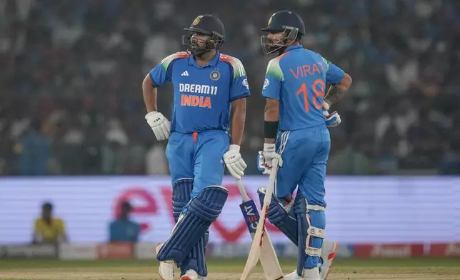 India's captain Rohit Sharma, left, and Virat Kohli await a DRS review during the second one day international cricket match between India and England in Cuttack, India, Sunday, Feb. 9, 2025. (AP Photo/Rafiq Maqbool)