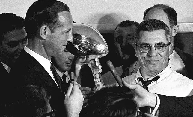FILE - Football Commissioner Pete Rozelle, left, presents the trophy to Green Bay Packers coach Vince Lombardi after they beat the Kansas City Chiefs in the Super Bowl in Los Angeles, Jan. 15, 1967. (AP Photo/File)
