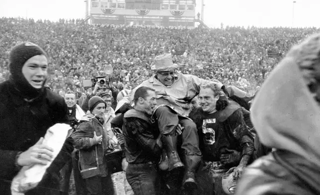 FILE - Green Bay Packers coach Vince Lombardi is carried off Lambeau Field on the shoulders of fullback Jimmy Taylor, left, and Paul Hornung after winning the NFL championship when they defeated the Cleveland Browns 23-12 in Green Bay, Wis., on Jan. 2, 1966. (AP Photo/File)