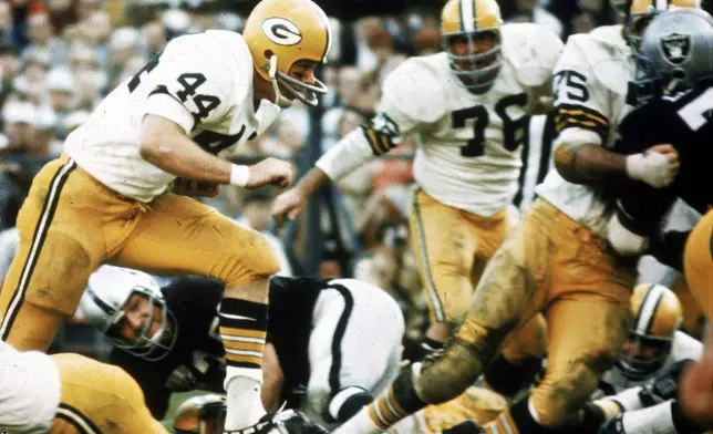 FILE - Green Bay Packers running back Donny Anderson (44) finds a hole in the Oakland Raiders defense and scores a touchdown during Super Bowl II at the Orange Bowl in Miami, Fla., on Sunday, Jan. 14, 1968. (AP Photo/File)