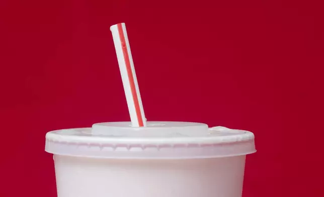 FILE- A large soft drink with a plastic straw from a McDonald's restaurant is shown in Surfside, Fla., May 24, 2018. (AP Photo/Wilfredo Lee, File)