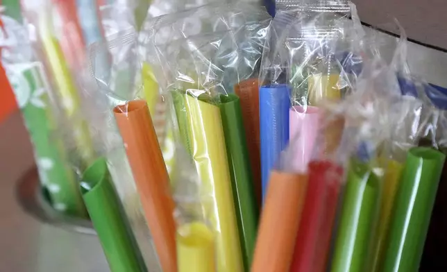 FILE - Wrapped plastic straws are seen at a bubble tea cafe in San Francisco, July 17, 2018. (AP Photo/Jeff Chiu, File)