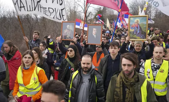 Students march near the village of Cumic near the Serbian industrial town of Kragujevac, to protest the deaths of 15 people killed in the November collapse of a train station canopy, Friday, Feb. 14, 2025. (AP Photo/Darko Vojinovic)