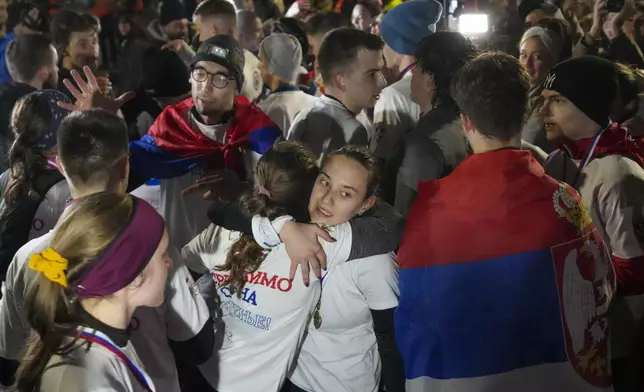 People welcome students in the Serbian industrial town of Kragujevac, who have arrived to protest the deaths of 15 people killed in the November collapse of a train station canopy, Friday, Feb. 14, 2025. (AP Photo/Darko Vojinovic)