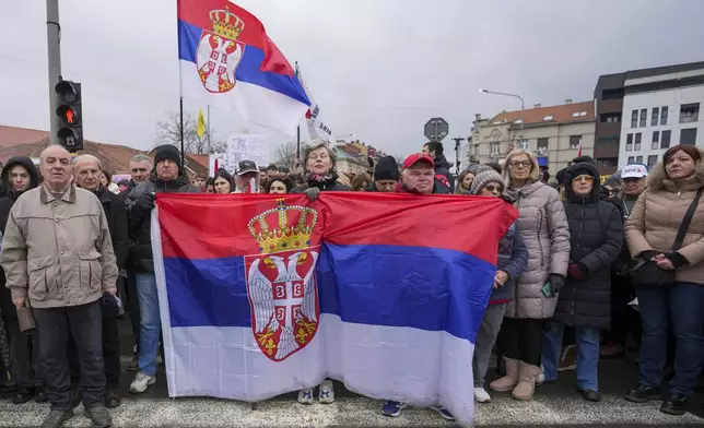People attend a minute of silence during a protest triggered after a concrete canopy on a railway station in the northern city of Novi Sad collapsed on Nov. 1, 2024 killed 15 people, in Kragujevac, Serbia, Saturday, Feb. 15, 2025. (AP Photo/Darko Vojinovic)
