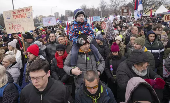 People attend a moment of silence during a protest triggered after a concrete canopy on a railway station in the northern city of Novi Sad collapsed on Nov. 1, 2024 killed 15 people, in Kragujevac, Serbia, Saturday, Feb. 15, 2025. (AP Photo/Darko Vojinovic)