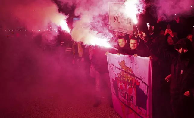 People welcome students in the Serbian industrial town of Kragujevac, who have arrived to protest the deaths of 15 people killed in the November collapse of a train station canopy, Friday, Feb. 14, 2025. (AP Photo/Darko Vojinovic)