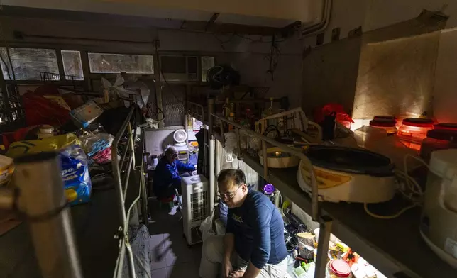 Resident Law Chung-yu sits in his bed space in Sham Shui Po district of Hong Kong, on Feb. 6, 2025. (AP Photo/Chan Long Hei)
