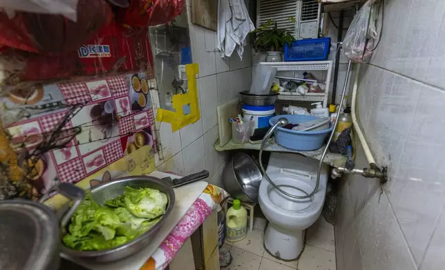 A toilet and kitchen are located in the same area of a subdivided flat in Sham Shui Po district of Hong Kong, on Feb. 6, 2025. (AP Photo/Chan Long Hei)