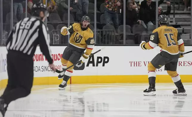 Vegas Golden Knights left wing Brandon Saad (20) celebrates after scoring against the Vancouver Canucks during the third period of an NHL hockey game Saturday, Feb. 22, 2025, in Las Vegas. (AP Photo/John Locher)