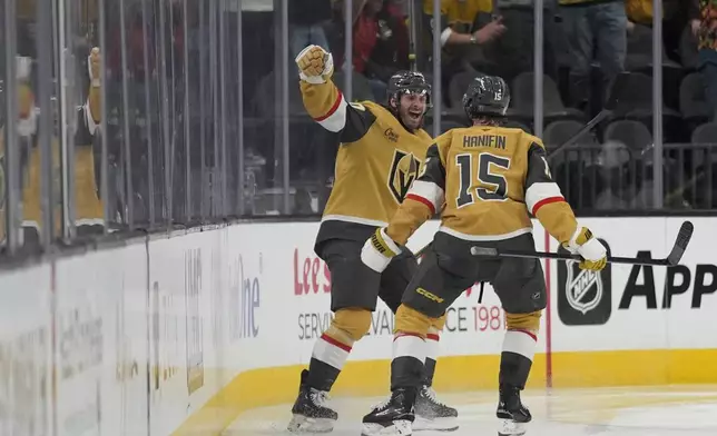 Vegas Golden Knights left wing Brandon Saad, left, celebrates after scoring against the Vancouver Canucks during the third period of an NHL hockey game Saturday, Feb. 22, 2025, in Las Vegas. (AP Photo/John Locher)