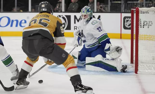 Vegas Golden Knights right wing Victor Olofsson (95) looks to shoot against Vancouver Canucks goaltender Kevin Lankinen (32) during the second period of an NHL hockey game Saturday, Feb. 22, 2025, in Las Vegas. (AP Photo/John Locher)