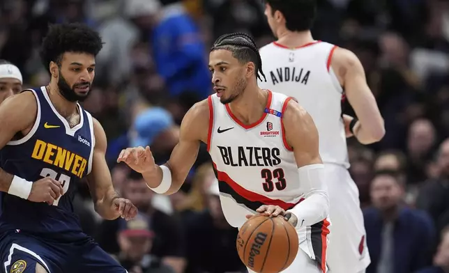 Portland Trail Blazers forward Toumani Camara, right, drives to the basket as Denver Nuggets guard Jamal Murray defends in the first half of an NBA basketball game Wednesday, Feb. 12, 2025, in Denver. (AP Photo/David Zalubowski)