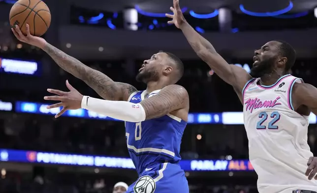 Milwaukee Bucks' Damian Lillard shoots past Miami Heat's Andrew Wiggins during the second half of an NBA basketball game Sunday, Feb. 23, 2025, in Milwaukee. (AP Photo/Morry Gash)