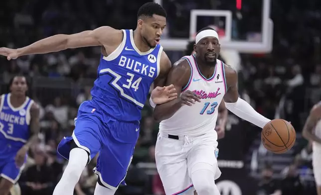 Miami Heat's Bam Adebayo tries to get past Milwaukee Bucks' Giannis Antetokounmpo during the first half of an NBA basketball game Sunday, Feb. 23, 2025, in Milwaukee. (AP Photo/Morry Gash)