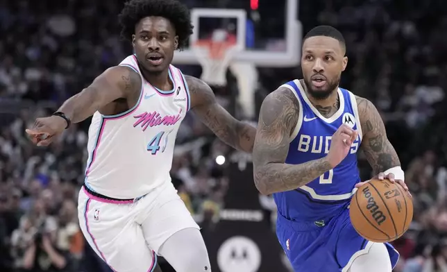Milwaukee Bucks' Damian Lillard drives past Miami Heat's Davion Mitchell during the second half of an NBA basketball game Sunday, Feb. 23, 2025, in Milwaukee. (AP Photo/Morry Gash)