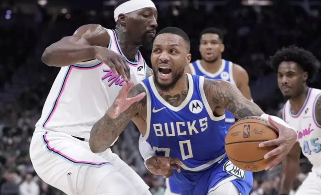 Milwaukee Bucks' Damian Lillard tries to get past Miami Heat's Bam Adebayo during the second half of an NBA basketball game Sunday, Feb. 23, 2025, in Milwaukee. (AP Photo/Morry Gash)