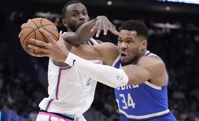Miami Heat's Andrew Wiggins fouls Milwaukee Bucks' Giannis Antetokounmpo during the second half of an NBA basketball game Sunday, Feb. 23, 2025, in Milwaukee. (AP Photo/Morry Gash)